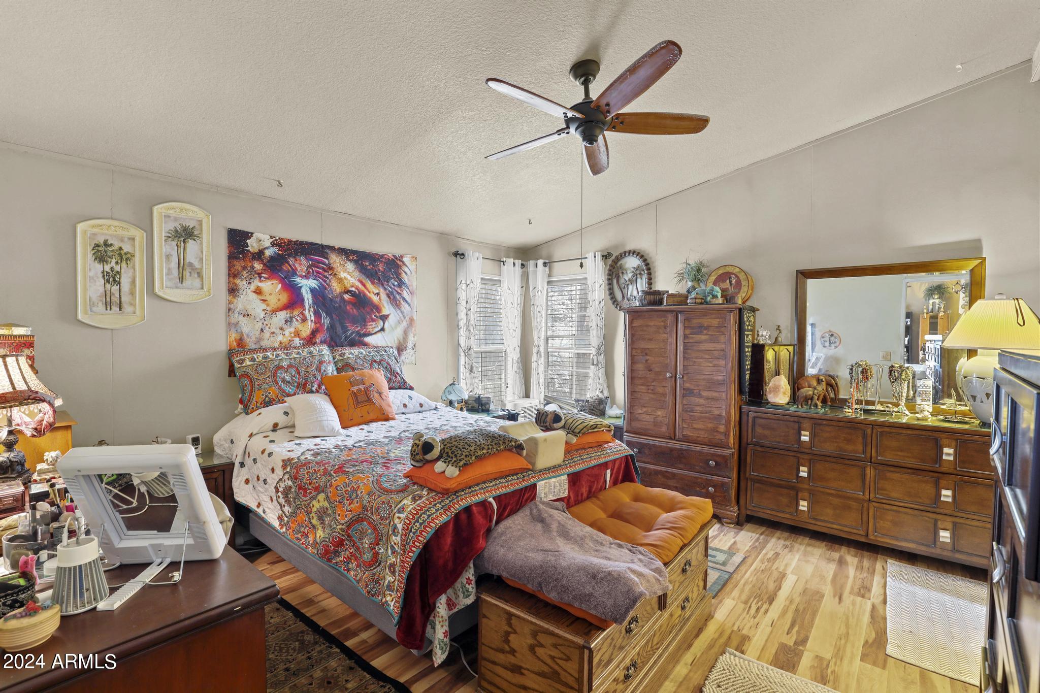 308 East Cherry Street Payson, AZ 85541 - Photo 10 of 22 a bed room with a bed and a chandelier