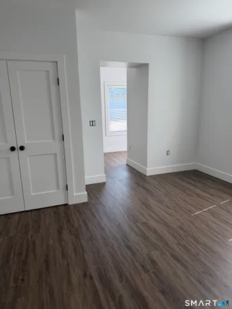 a view of a room with wooden floor and window