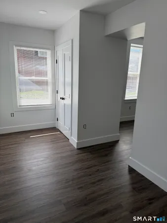 a bathroom with a granite countertop toilet and a sink