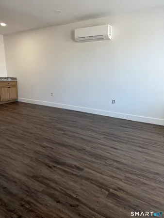 a view of a room with wooden floor