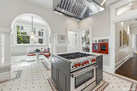 a close view of a stove a sink and dishwasher with wooden floor