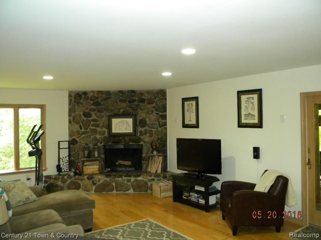 299 North Baldwin Road Oxford, MI 48371 - Photo 7 of 33 STONE FIREPLACE W/ HARDWOOD FLOORS