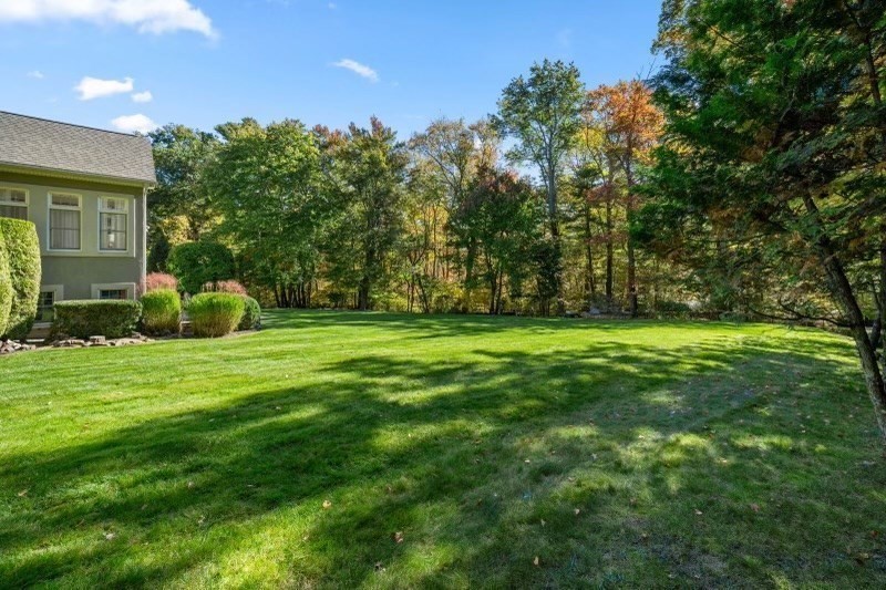 85 Colts Crossing Canton, MA 02021 - Photo 22 of 38 a backyard of a house with lots of green space