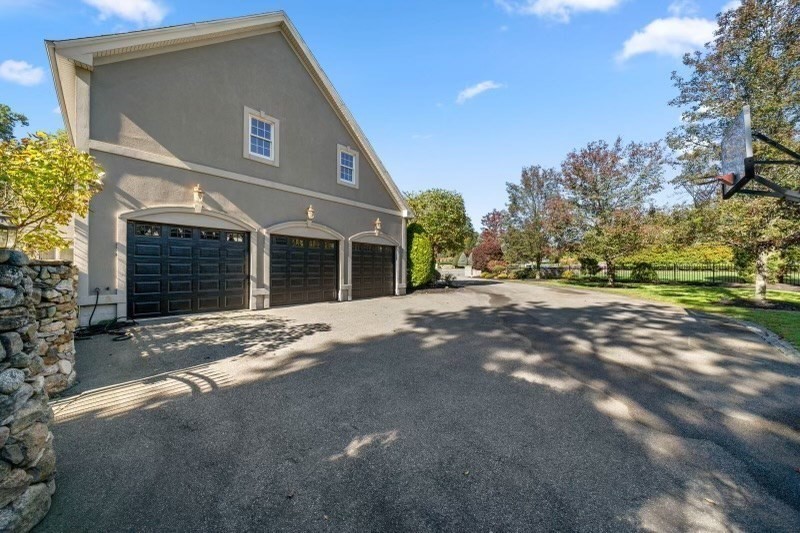 85 Colts Crossing Canton, MA 02021 - Photo 23 of 38 a front view of a house with a yard and garage
