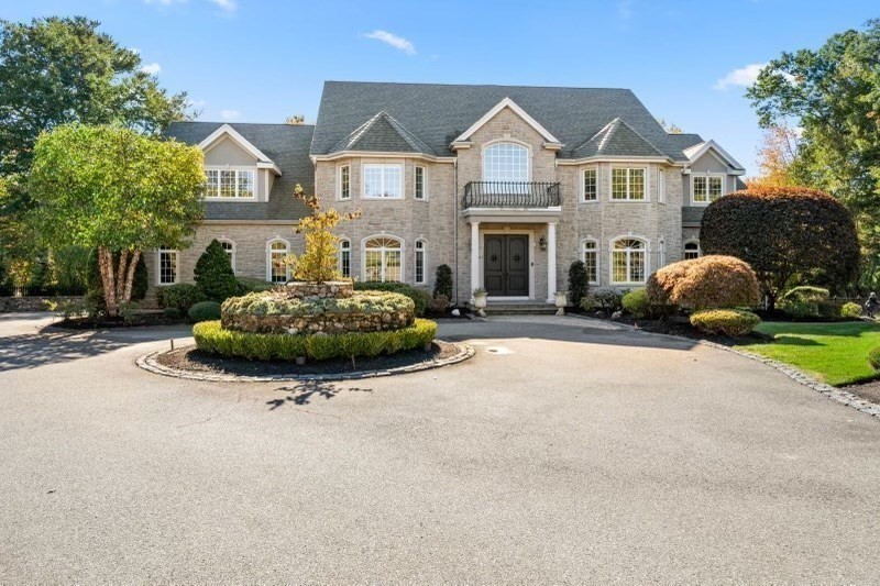 85 Colts Crossing Canton, MA 02021 - Photo 5 of 38 a front view of a house with a yard and garage