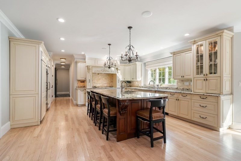 85 Colts Crossing Canton, MA 02021 - Photo 10 of 38 a kitchen with stainless steel appliances granite countertop a table chairs stove and kitchen island