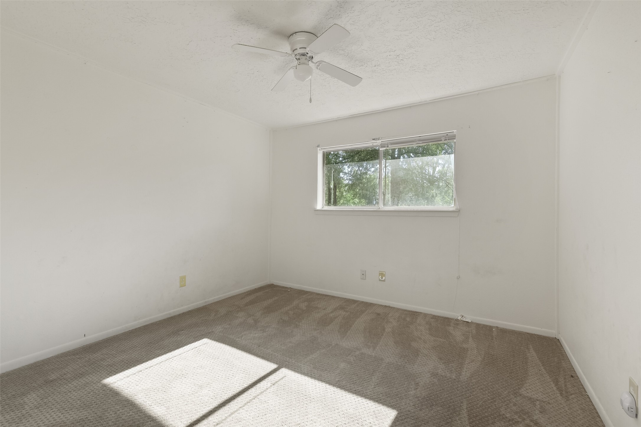 217 Lazy Lane, Unit B Conroe, TX 77301 - Photo 11 of 27 an empty room with a window