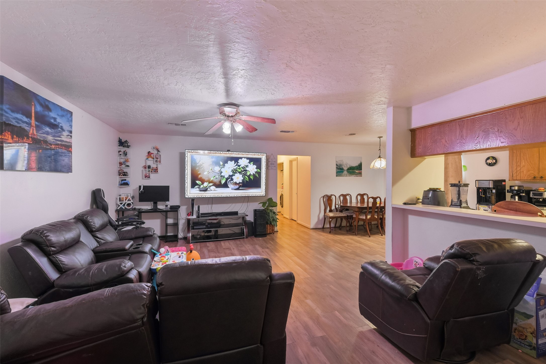 217 Lazy Lane, Unit B Conroe, TX 77301 - Photo 14 of 27 a living room with furniture a fireplace and a flat screen tv