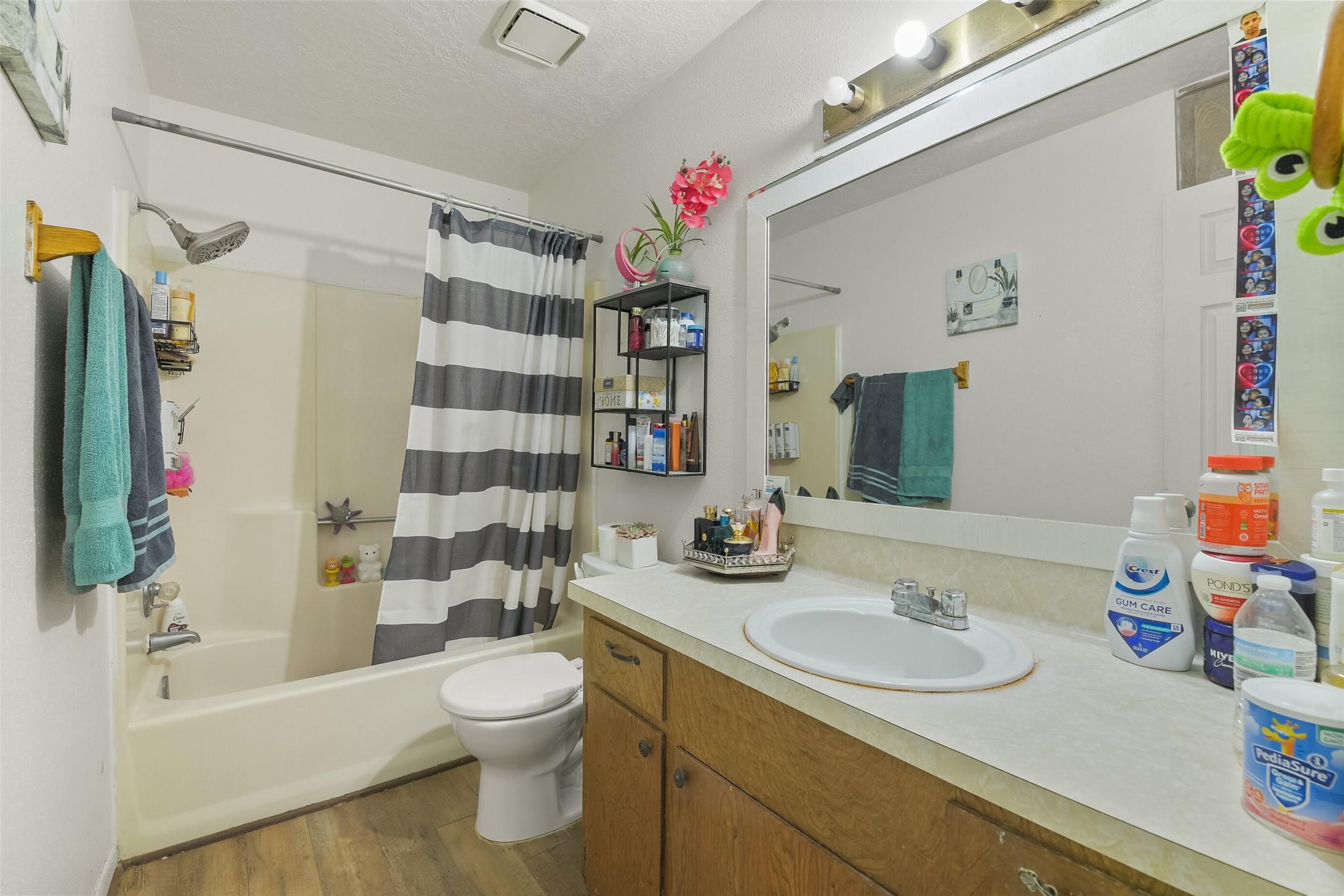 217 Lazy Lane, Unit B Conroe, TX 77301 - Photo 18 of 27 a bathroom with a granite countertop sink and a mirror