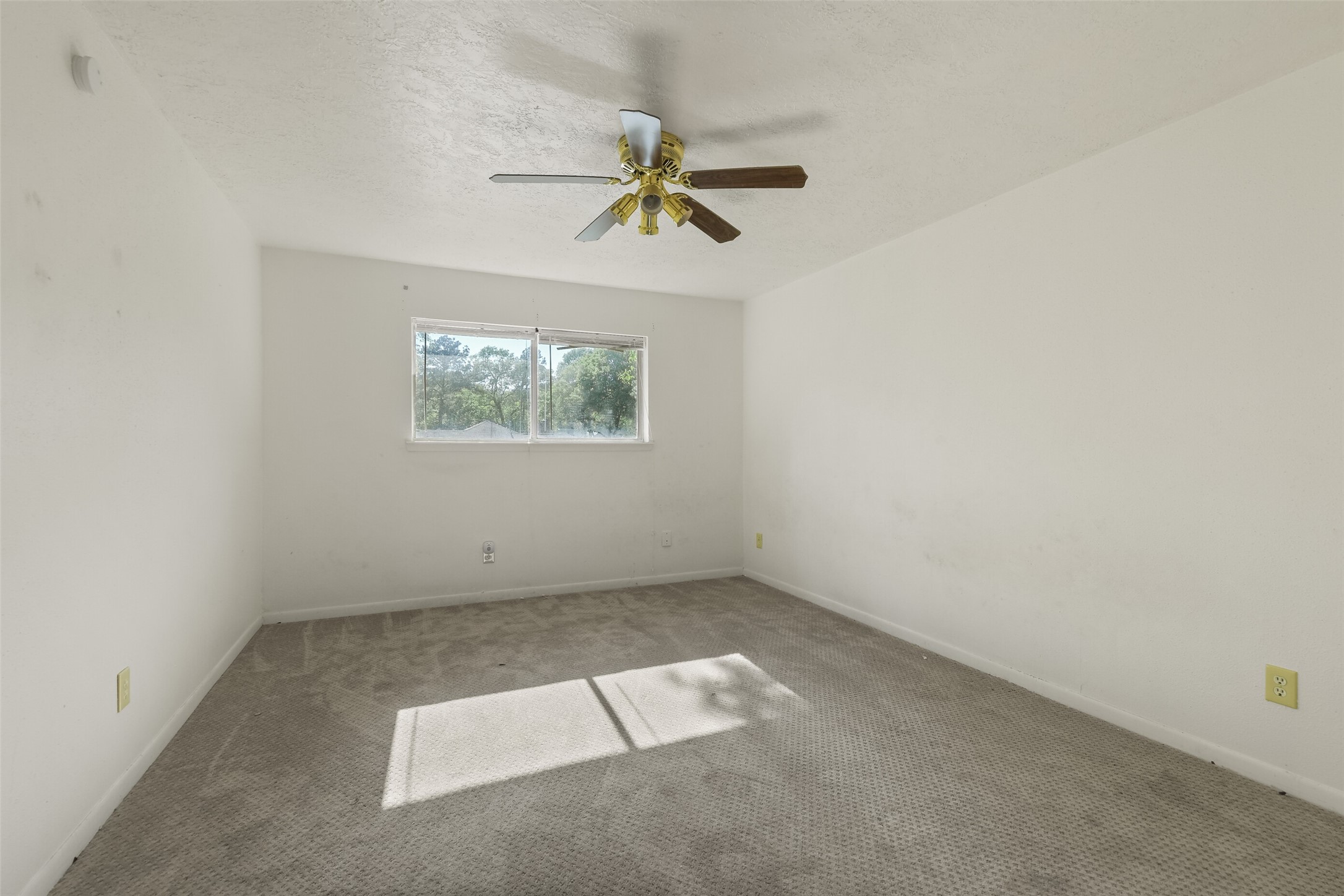 217 Lazy Lane, Unit B Conroe, TX 77301 - Photo 8 of 27 an empty room with windows