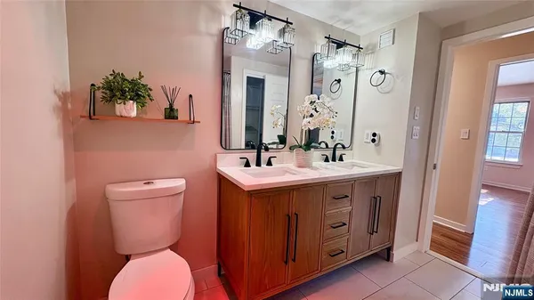 a hallway with a sink and a mirror