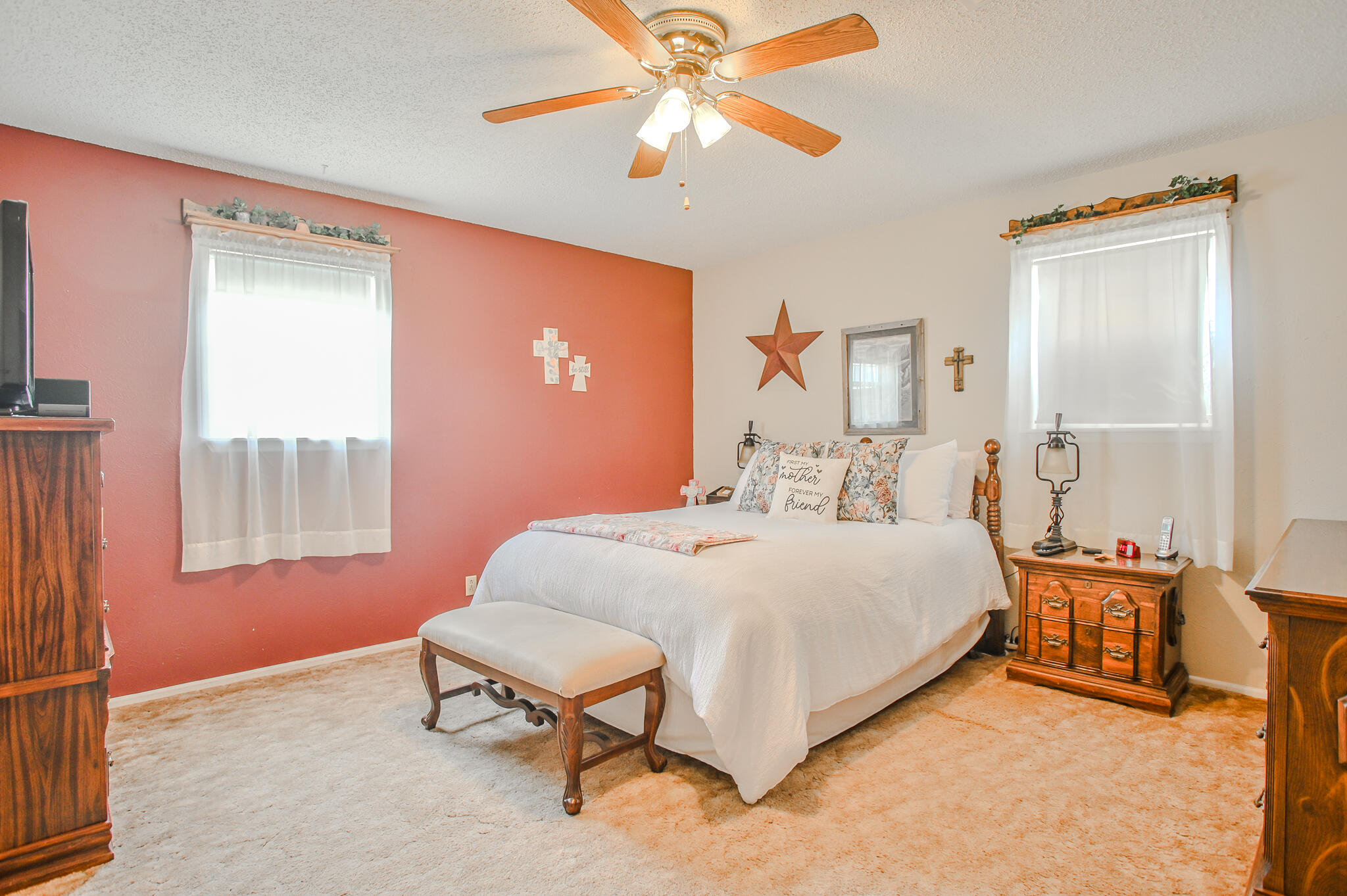 720 South 23rd Street Slaton, TX 79364 - Photo 12 of 46 a bedroom with a bed and a chandelier