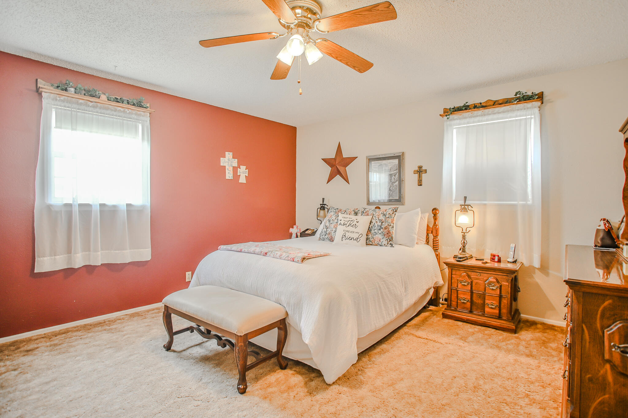 720 South 23rd Street Slaton, TX 79364 - Photo 13 of 46 a bedroom with a bed and a chandelier