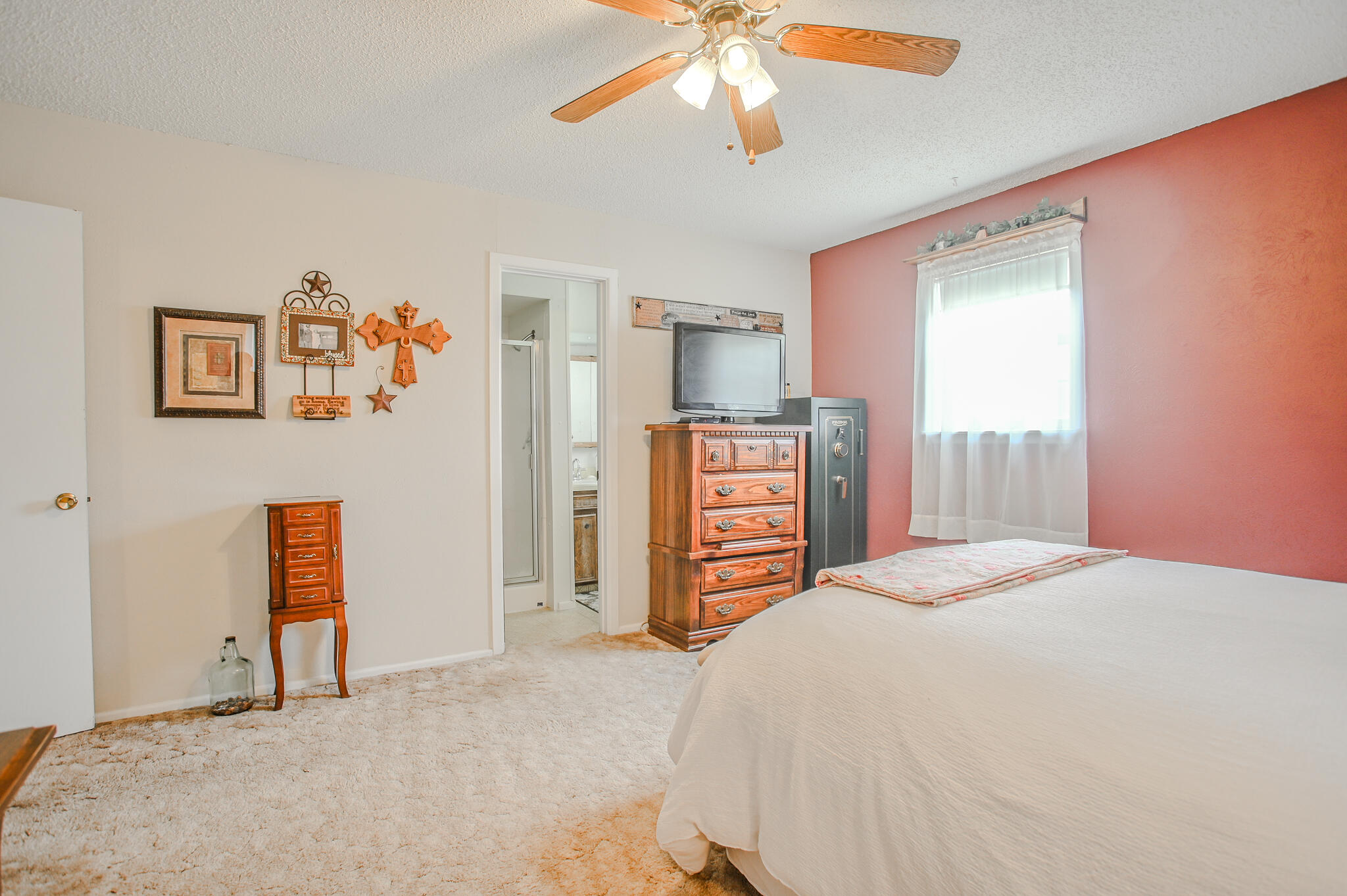 720 South 23rd Street Slaton, TX 79364 - Photo 14 of 46 a bedroom with a bed and a chandelier