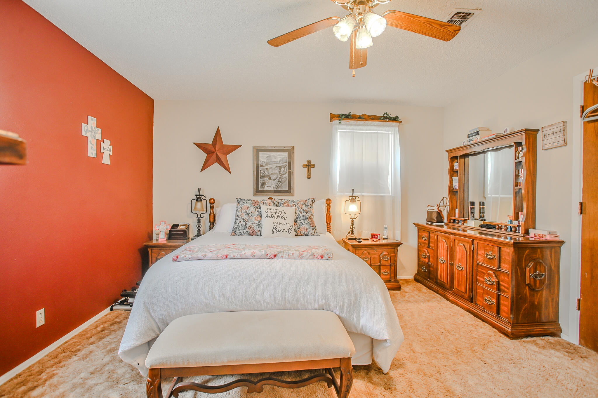 720 South 23rd Street Slaton, TX 79364 - Photo 15 of 46 a bedroom with a bed and a chandelier