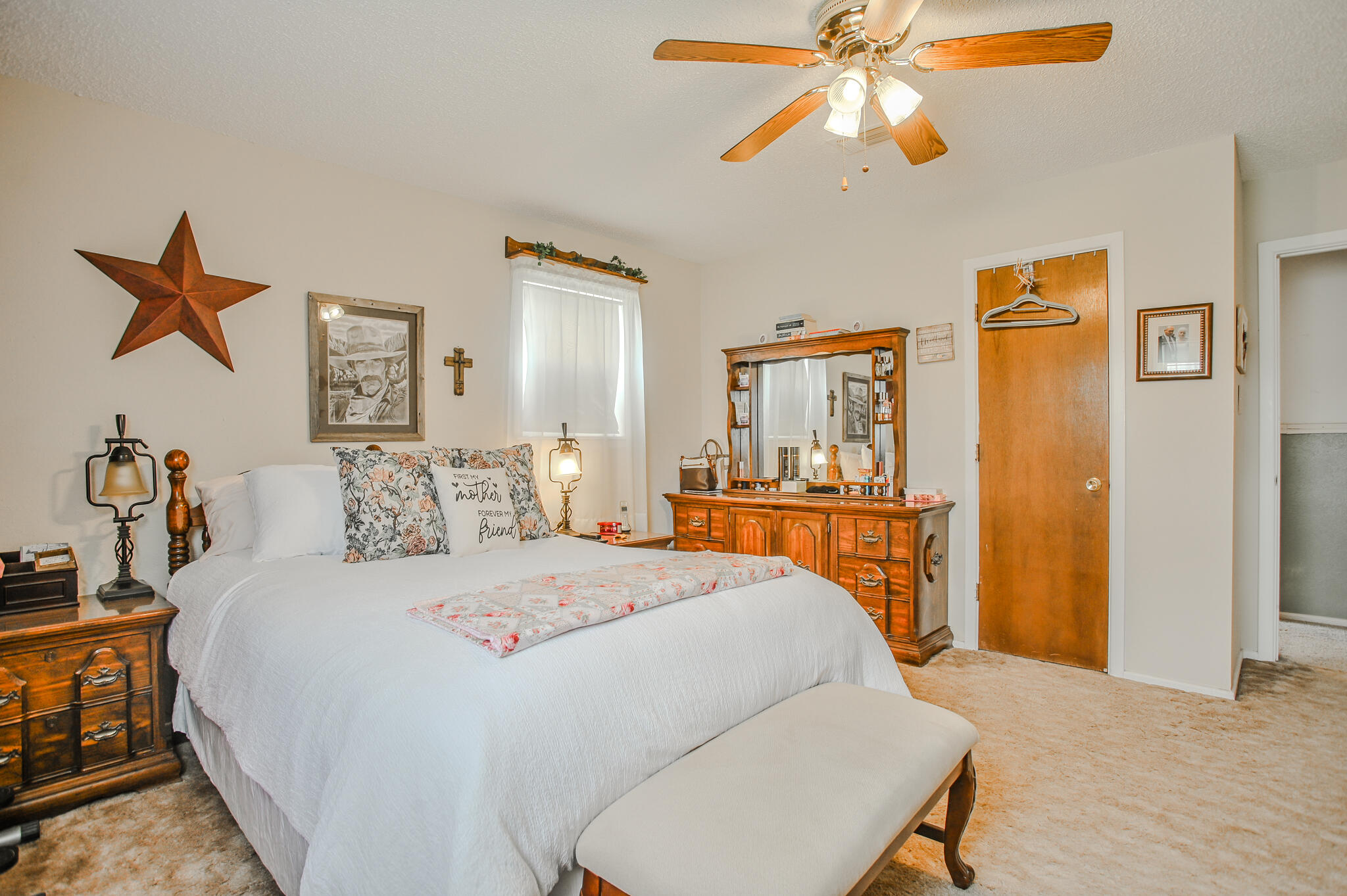 720 South 23rd Street Slaton, TX 79364 - Photo 16 of 46 a bedroom with a bed and a chandelier