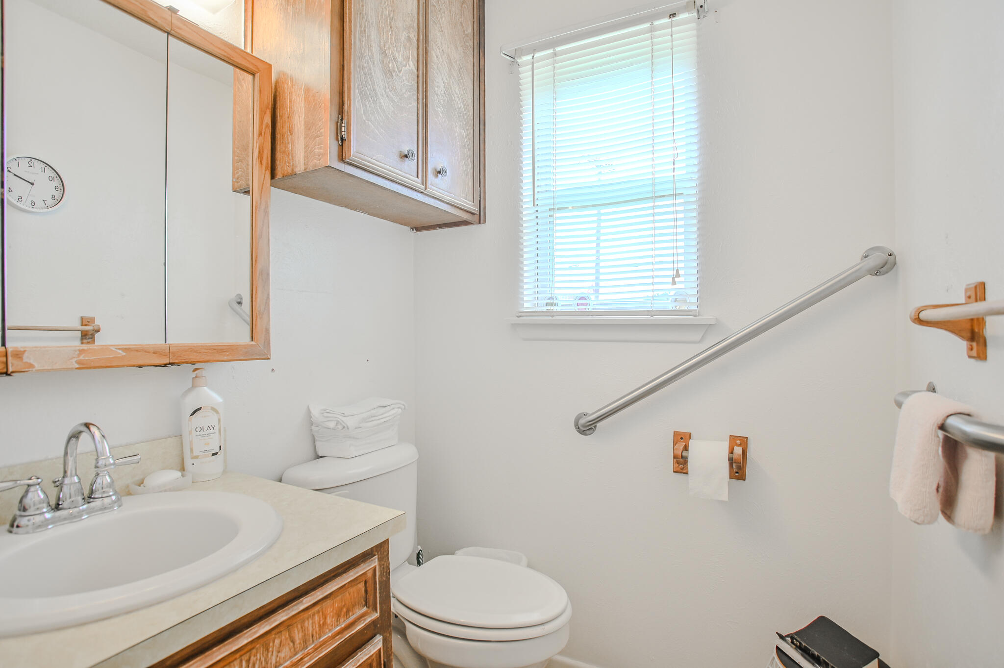 720 South 23rd Street Slaton, TX 79364 - Photo 18 of 46 a bathroom with a sink a toilet and a mirror