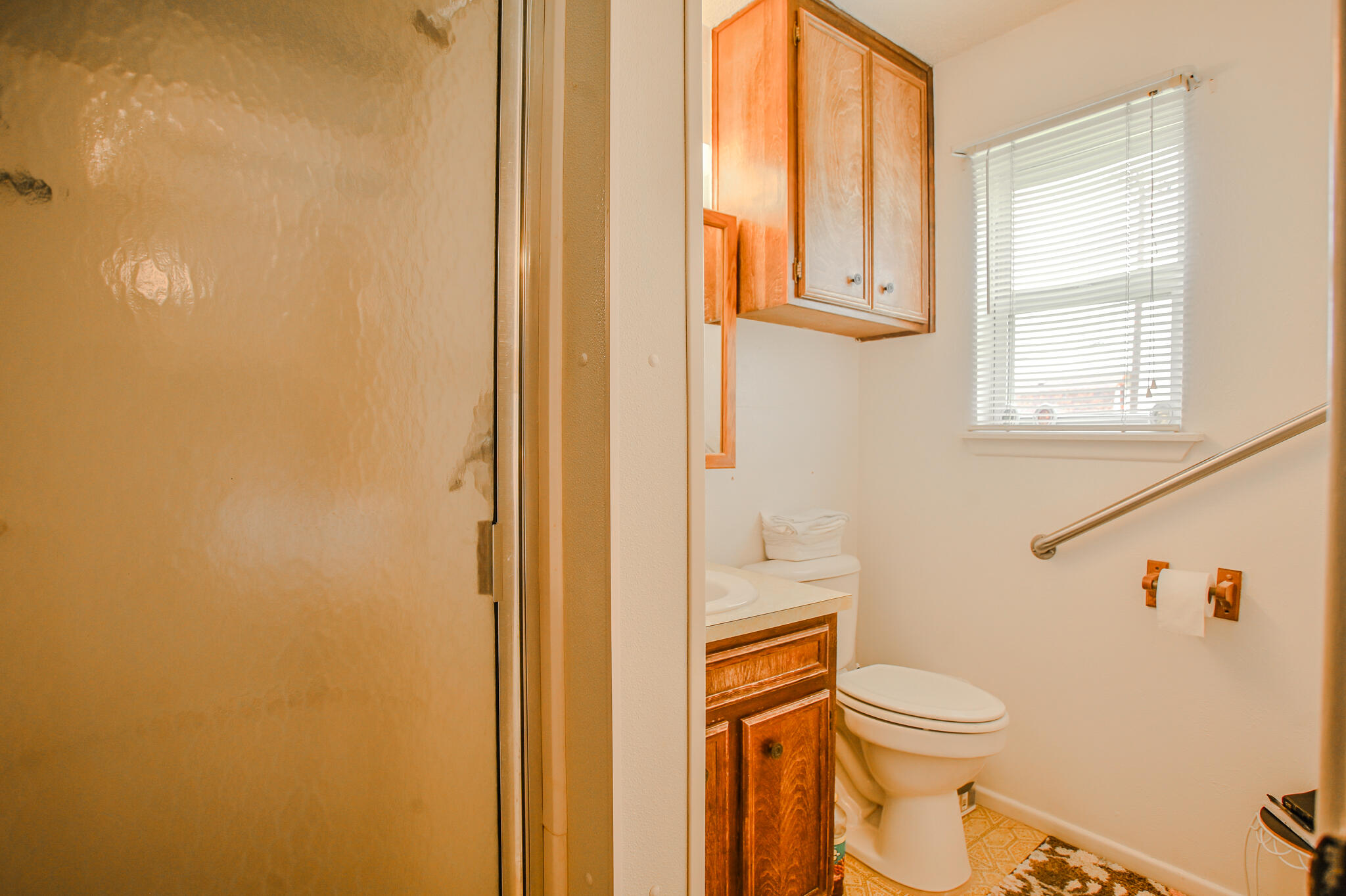 720 South 23rd Street Slaton, TX 79364 - Photo 19 of 46 a white toilet sitting next to a bathroom sink