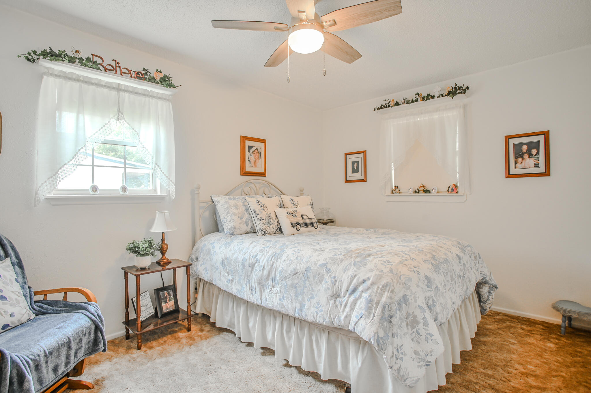 720 South 23rd Street Slaton, TX 79364 - Photo 20 of 46 a bedroom with a bed and a chandelier