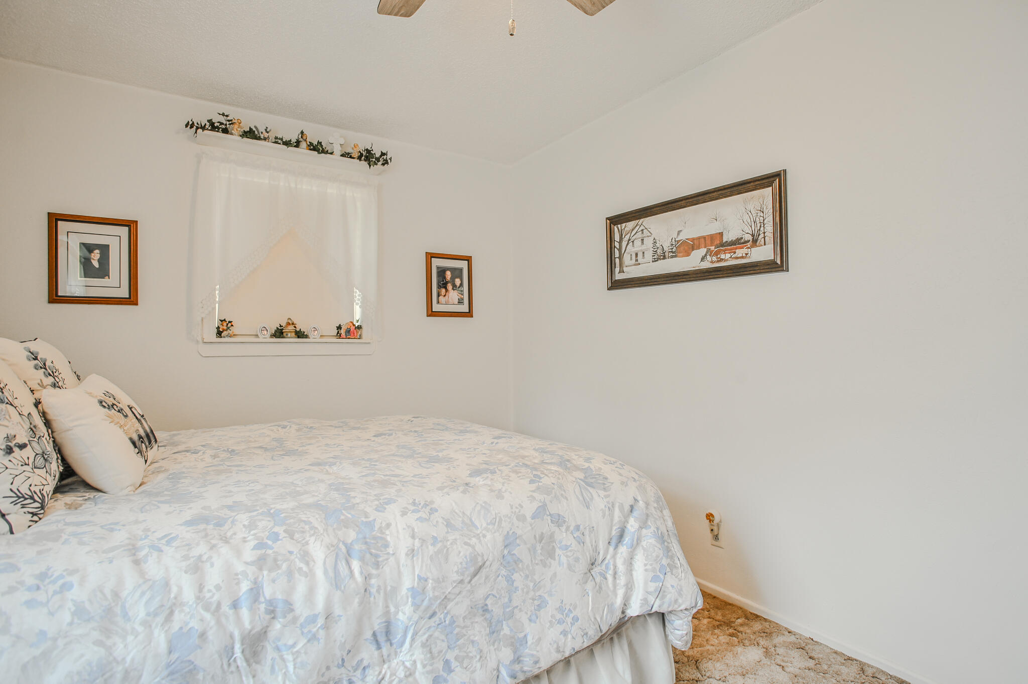 720 South 23rd Street Slaton, TX 79364 - Photo 21 of 46 a bedroom with a bed and a wall painting