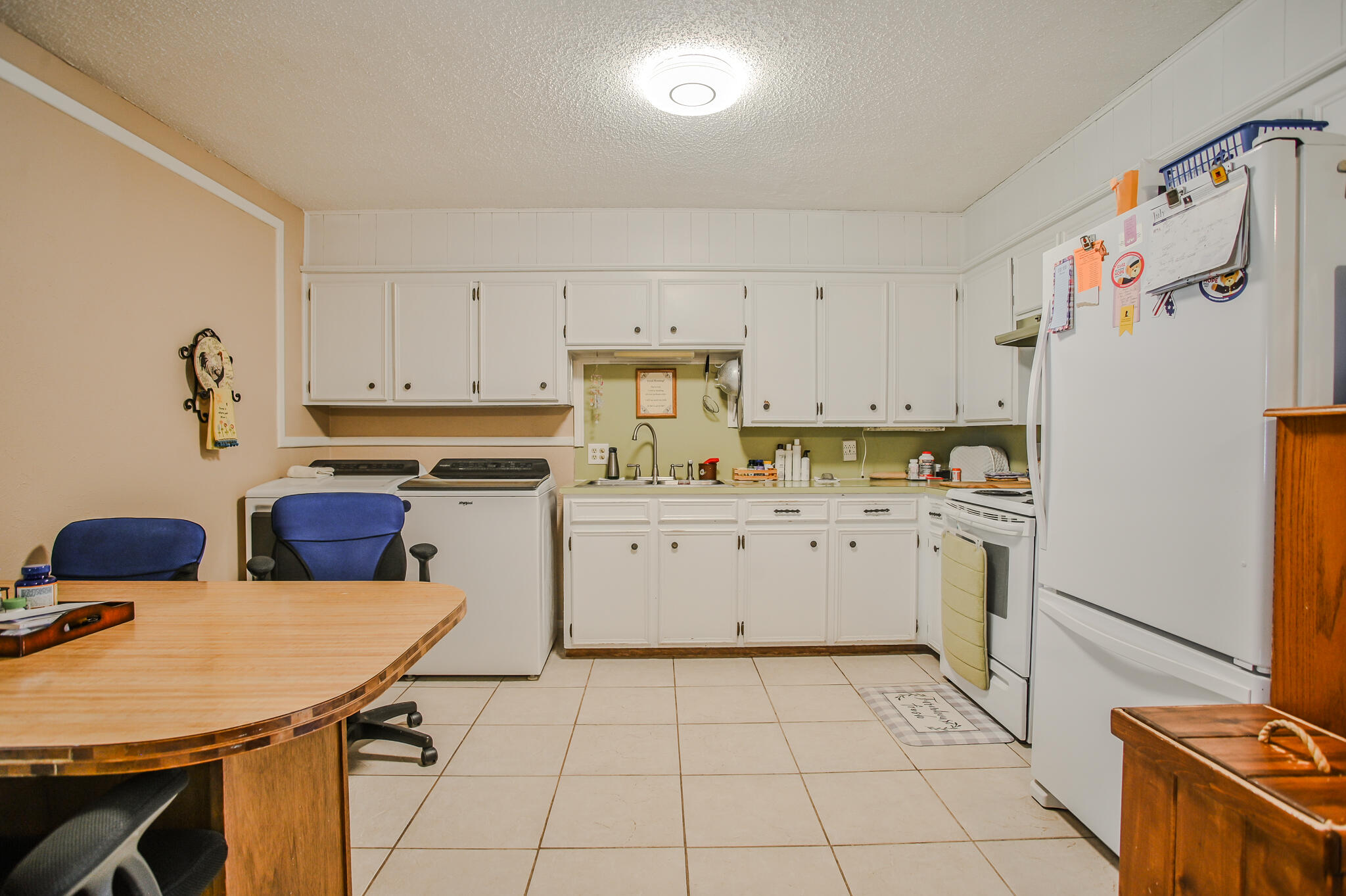 720 South 23rd Street Slaton, TX 79364 - Photo 25 of 46 a kitchen with a stove a refrigerator and a stove top oven