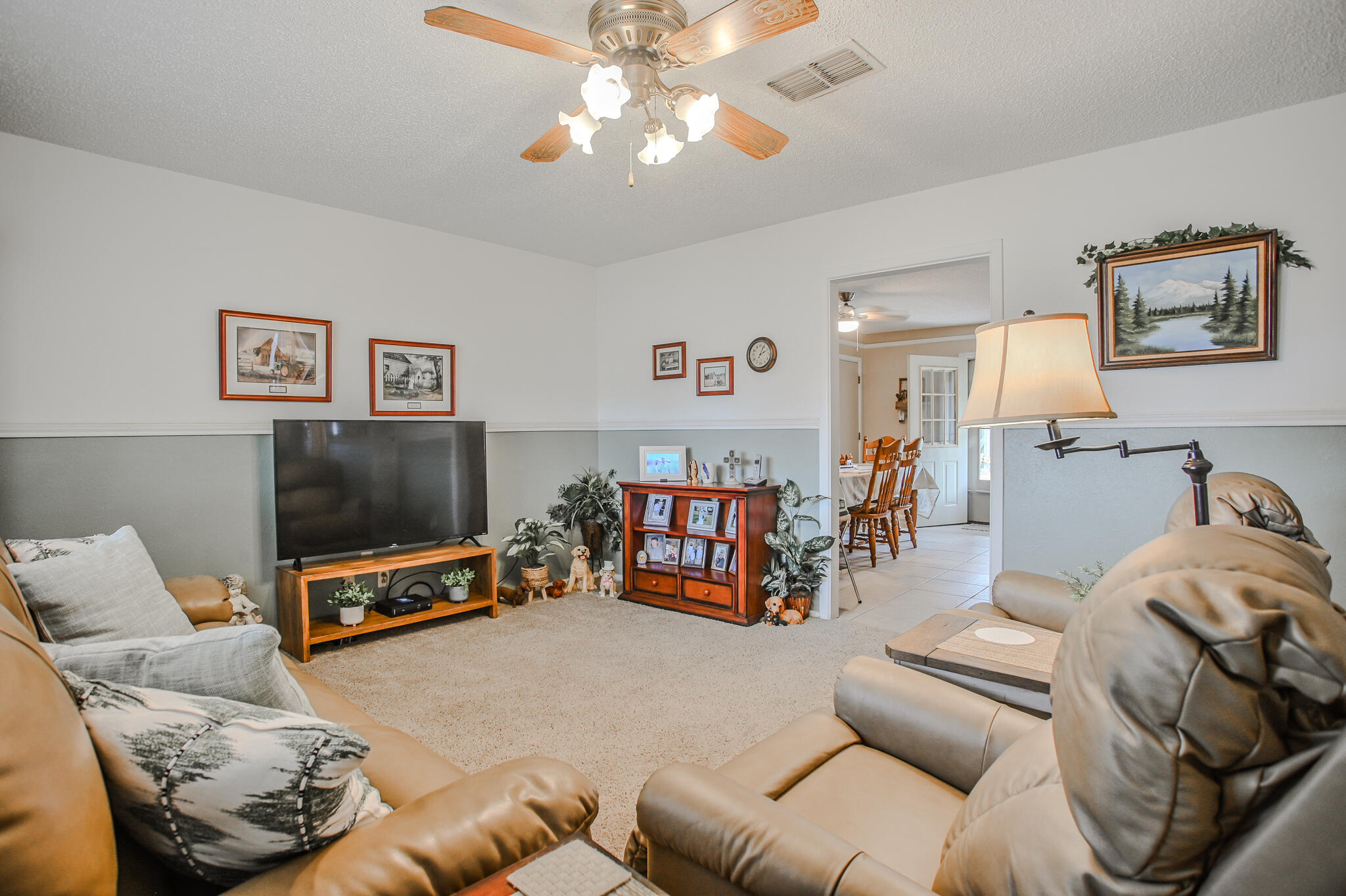 720 South 23rd Street Slaton, TX 79364 - Photo 3 of 46 a living room with furniture and a flat screen tv