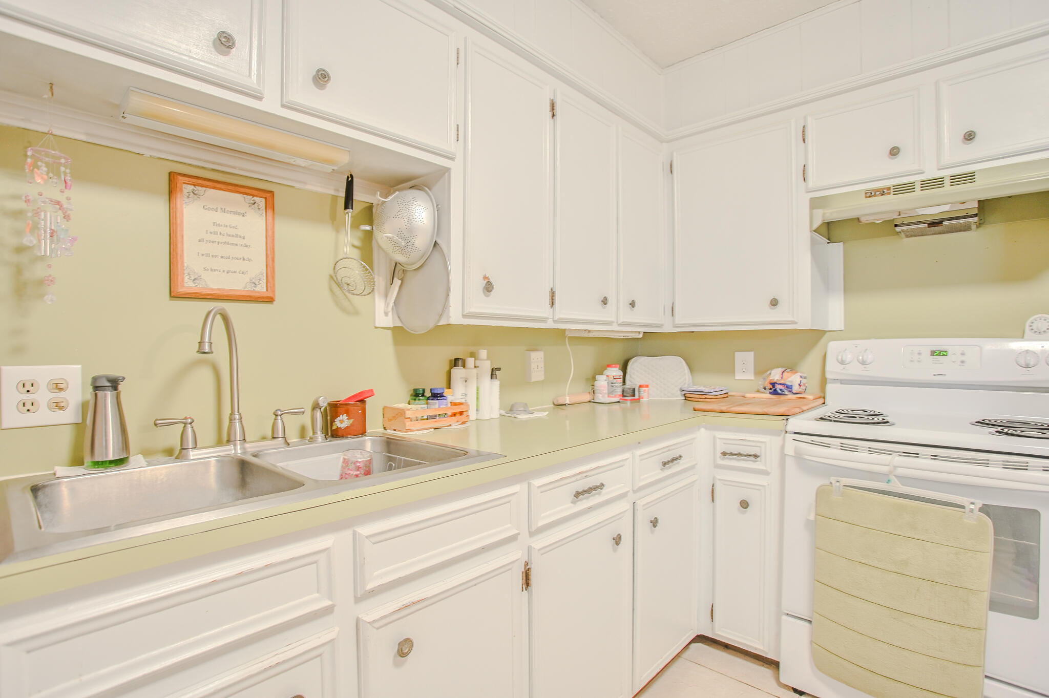 720 South 23rd Street Slaton, TX 79364 - Photo 33 of 46 a kitchen with white cabinets and white appliances