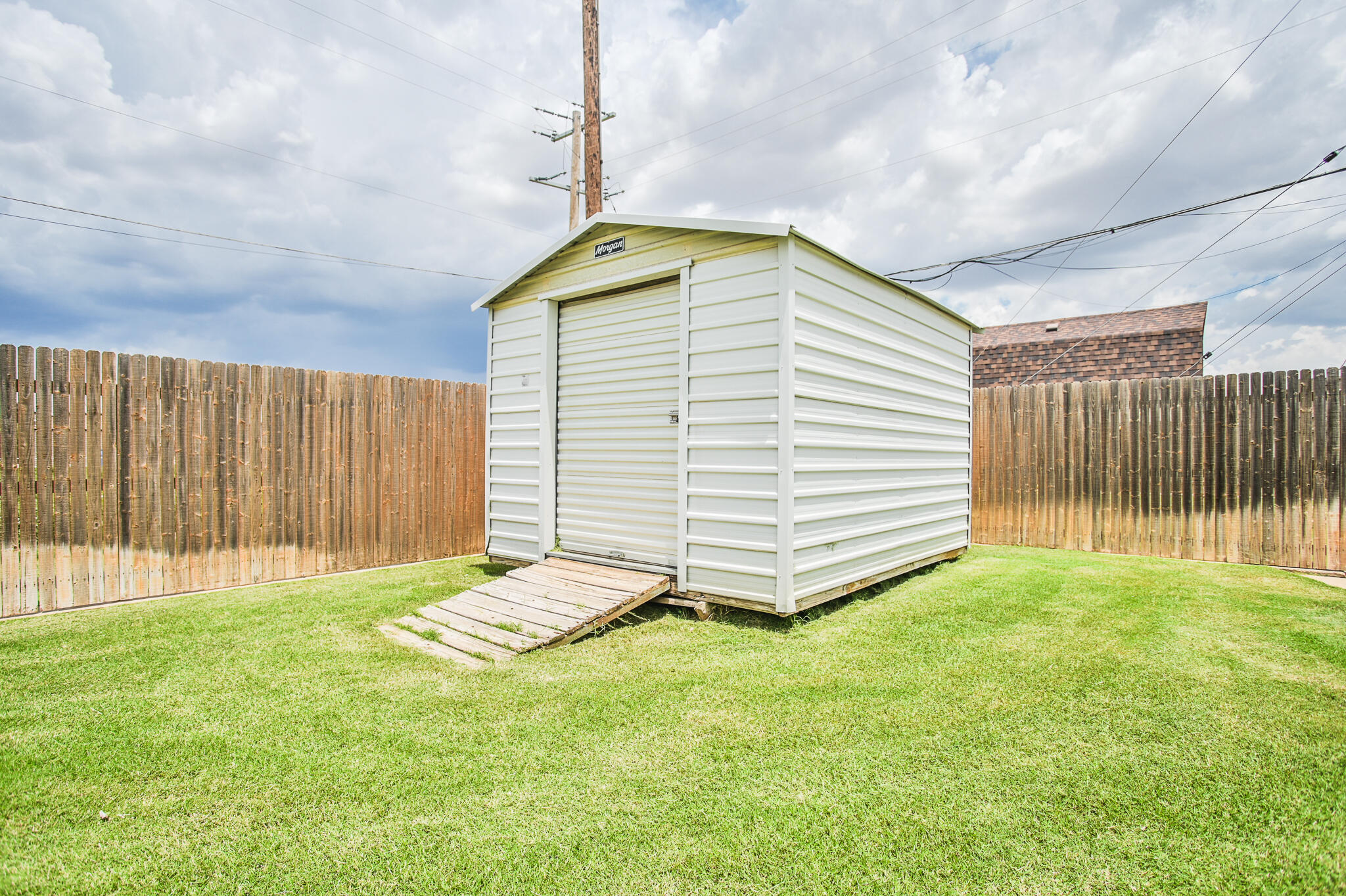 720 South 23rd Street Slaton, TX 79364 - Photo 39 of 46 a backyard of a house with a garden and entertaining space