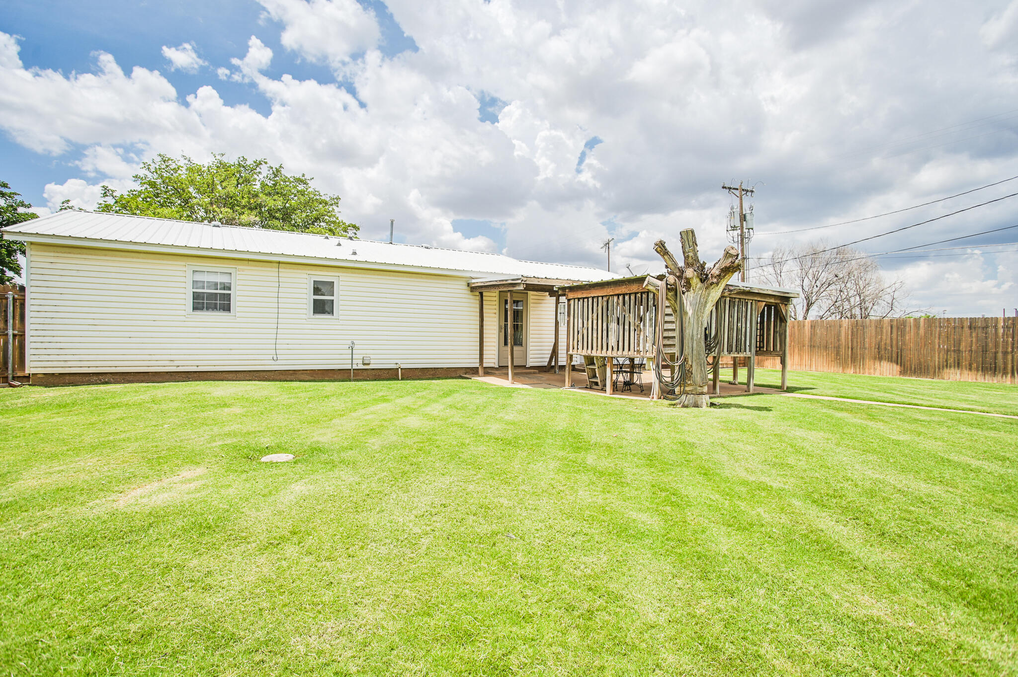 720 South 23rd Street Slaton, TX 79364 - Photo 44 of 46 a view of a house with a big yard and a large tree