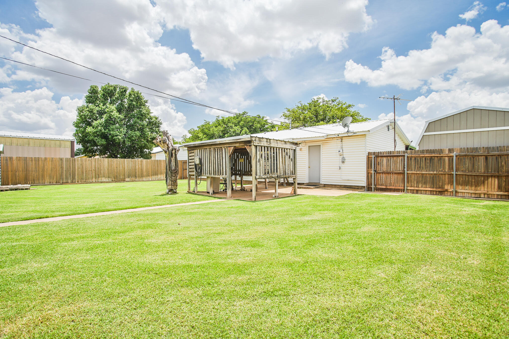 720 South 23rd Street Slaton, TX 79364 - Photo 45 of 46 a view of a house with a big yard and a large tree