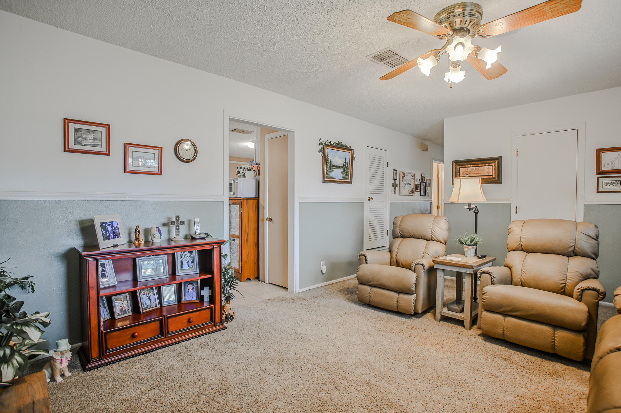 720 South 23rd Street Slaton, TX 79364 - Photo 5 of 46 a living room with furniture a baby crib and a book shelf