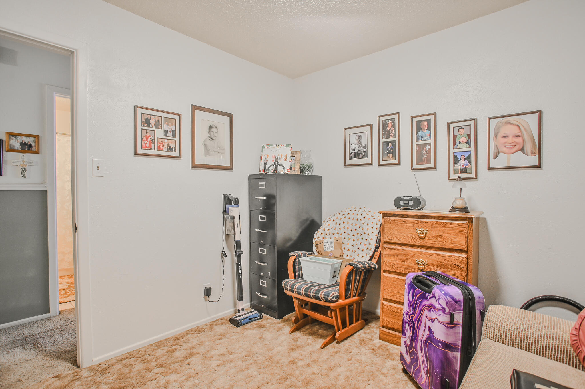 720 South 23rd Street Slaton, TX 79364 - Photo 8 of 46 a bedroom with a bed and furniture