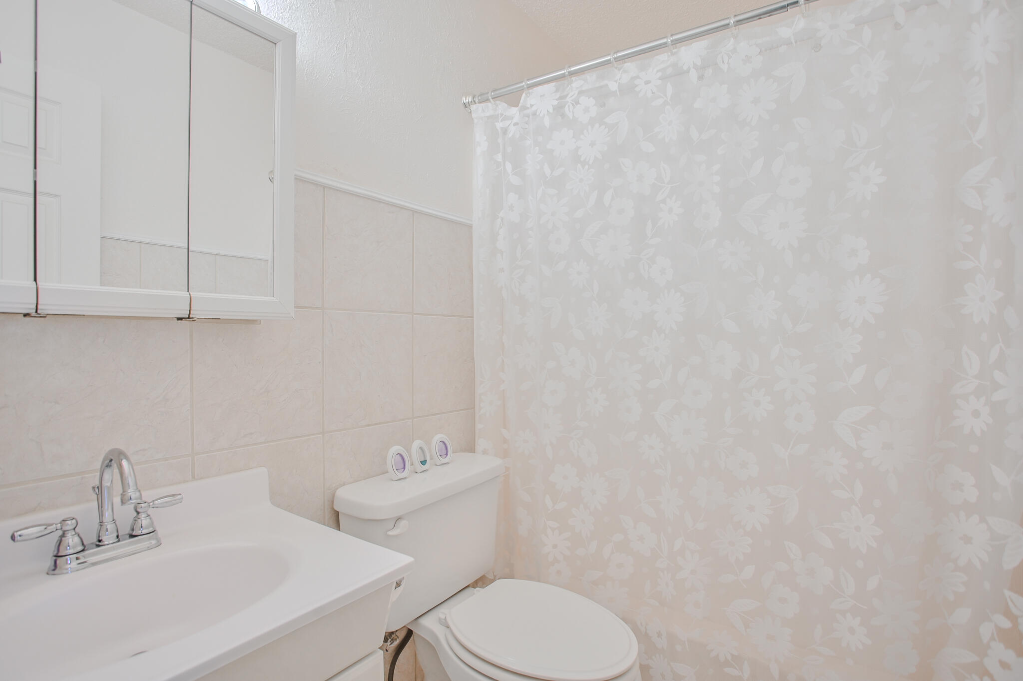 720 South 23rd Street Slaton, TX 79364 - Photo 10 of 46 a bathroom with a toilet a sink and mirror