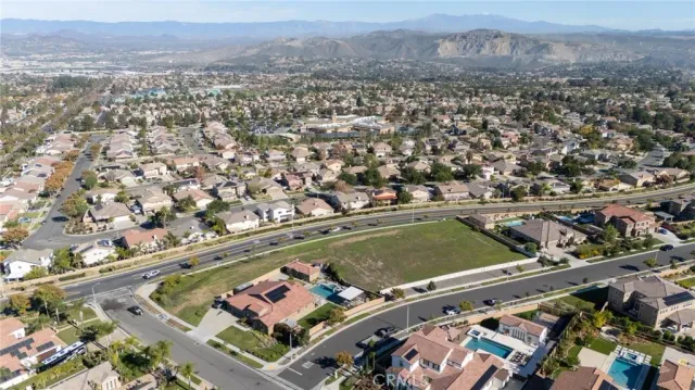 an aerial view of residential houses with outdoor space and seating