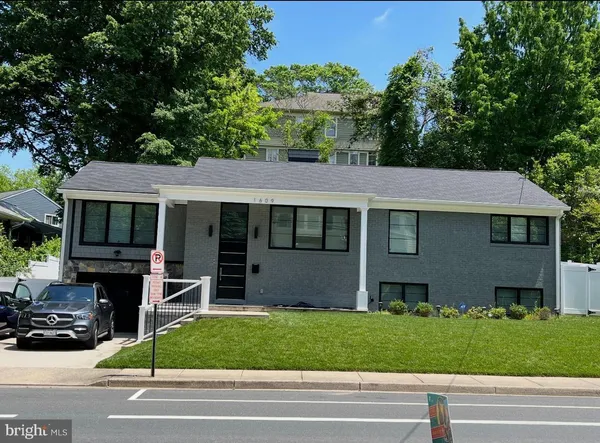 a view of a house with a garden and pathway