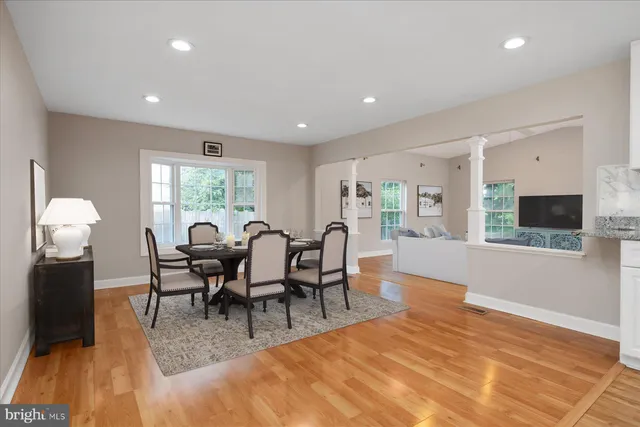a view of a dining room with furniture and wooden floor