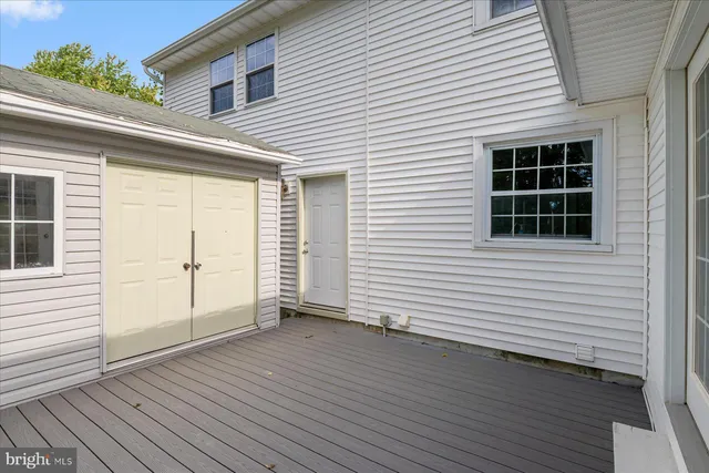 a view of backyard with deck and wooden floor