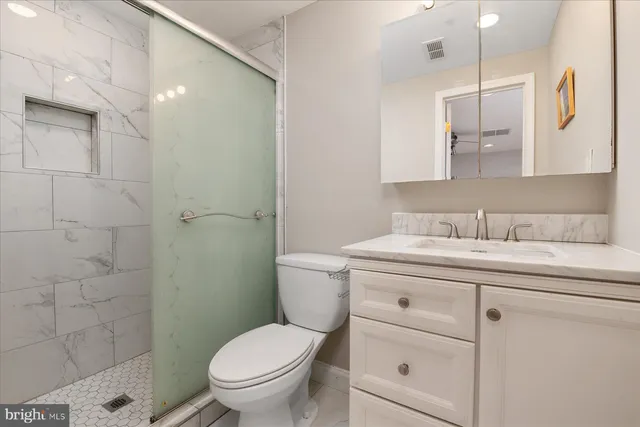 a bedroom with a bed window and dresser