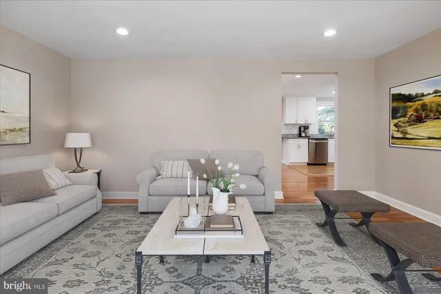 a living room with furniture a rug and a table