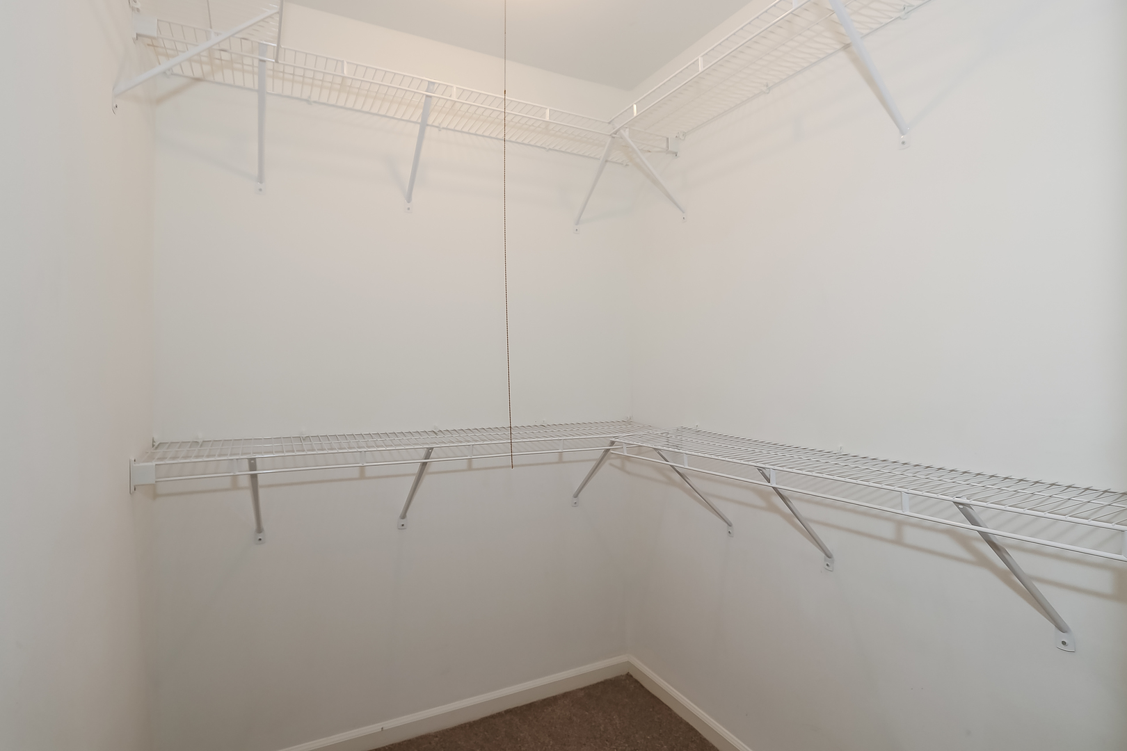 5000 Carriageway Drive, Unit 103 Rolling Meadows, IL 60008 - Photo 14 of 22 a view of a room with racks on the wall