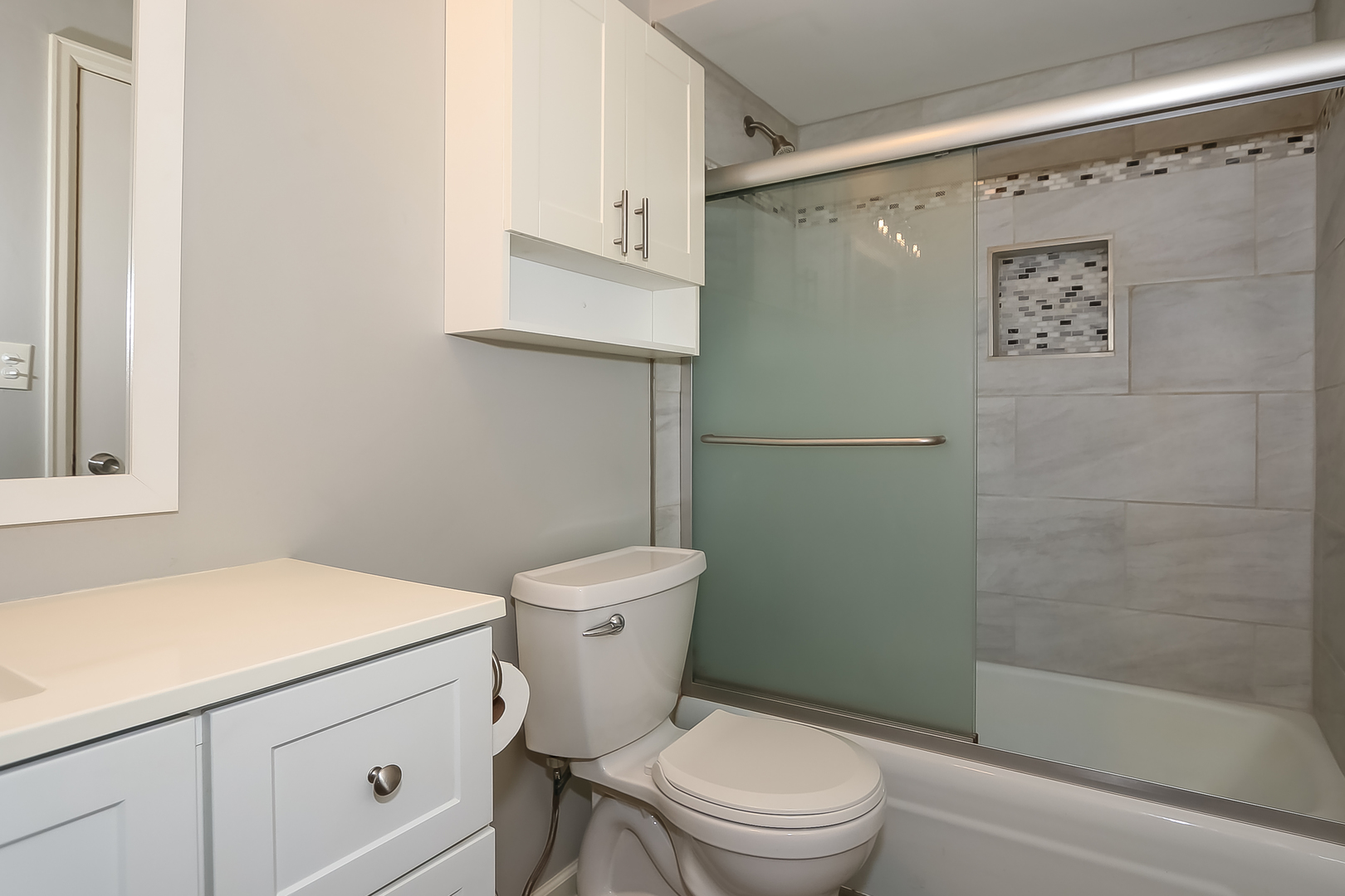 5000 Carriageway Drive, Unit 103 Rolling Meadows, IL 60008 - Photo 16 of 22 a white toilet sitting next to a bathroom sink