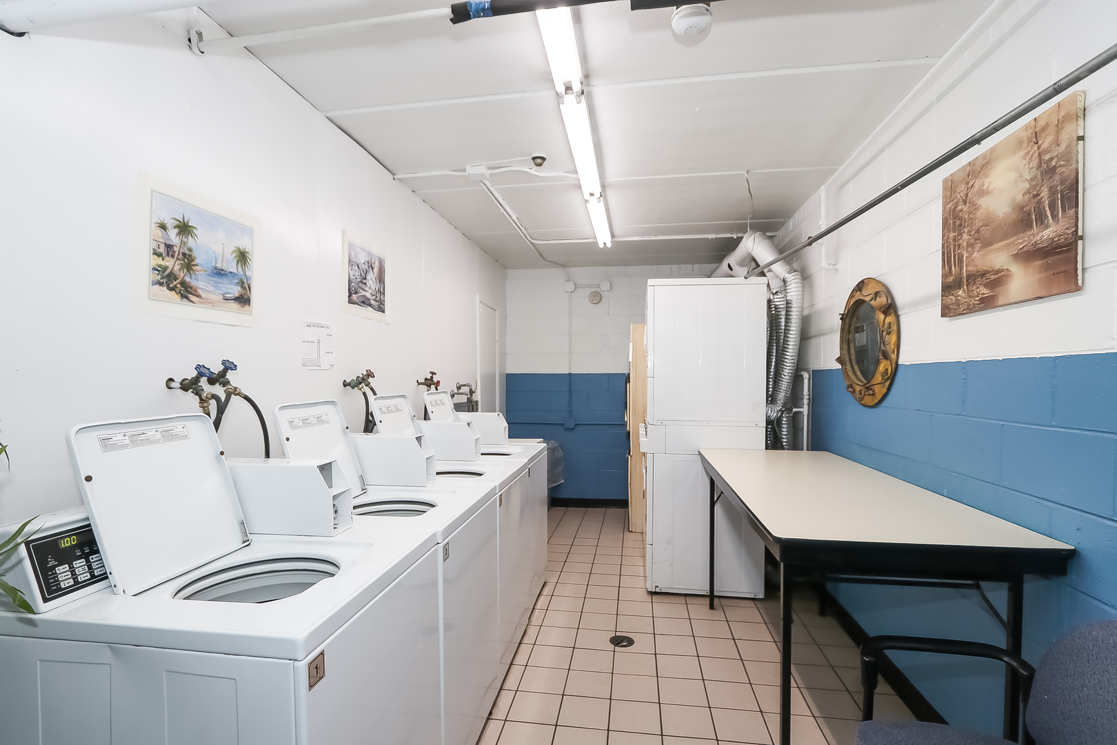 5000 Carriageway Drive, Unit 103 Rolling Meadows, IL 60008 - Photo 17 of 22 a white kitchen with a sink a stove a dining table and chairs