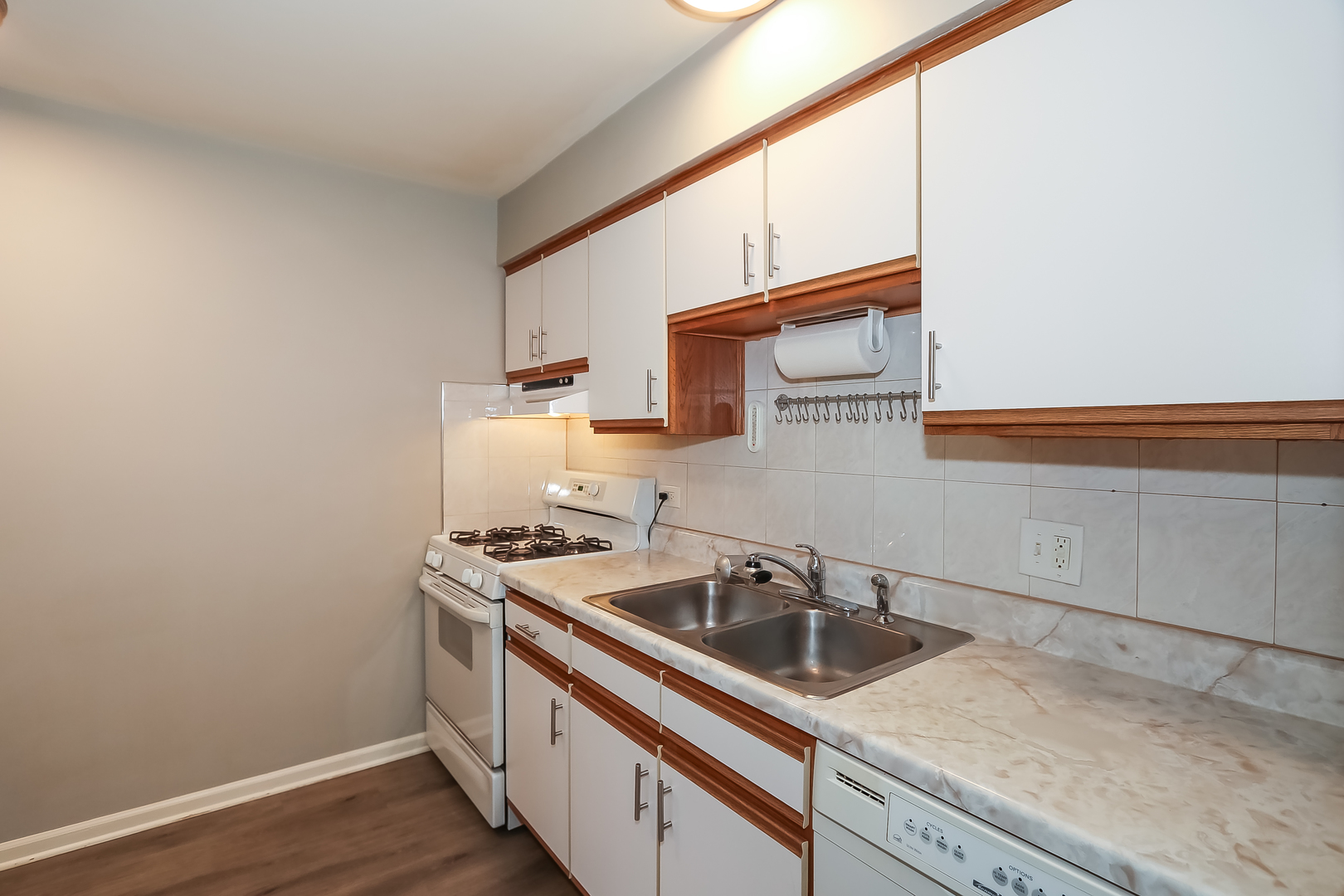 5000 Carriageway Drive, Unit 103 Rolling Meadows, IL 60008 - Photo 5 of 22 a view of a kitchen counter space a sink wooden floor and a window
