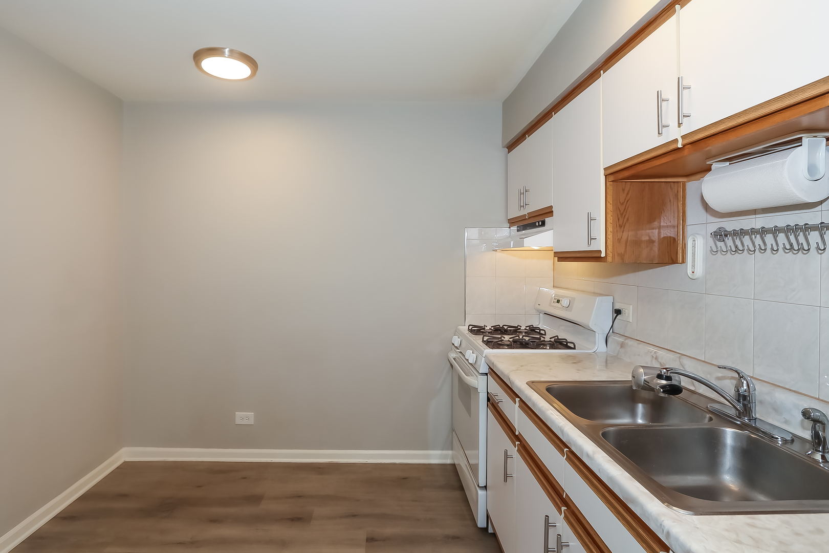 5000 Carriageway Drive, Unit 103 Rolling Meadows, IL 60008 - Photo 7 of 22 a kitchen with a sink and cabinets