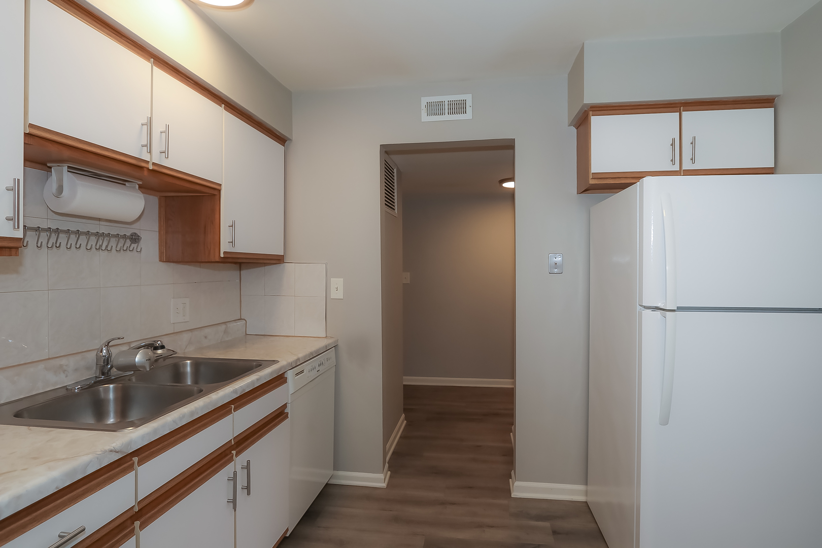 5000 Carriageway Drive, Unit 103 Rolling Meadows, IL 60008 - Photo 8 of 22 a kitchen with a sink and a refrigerator