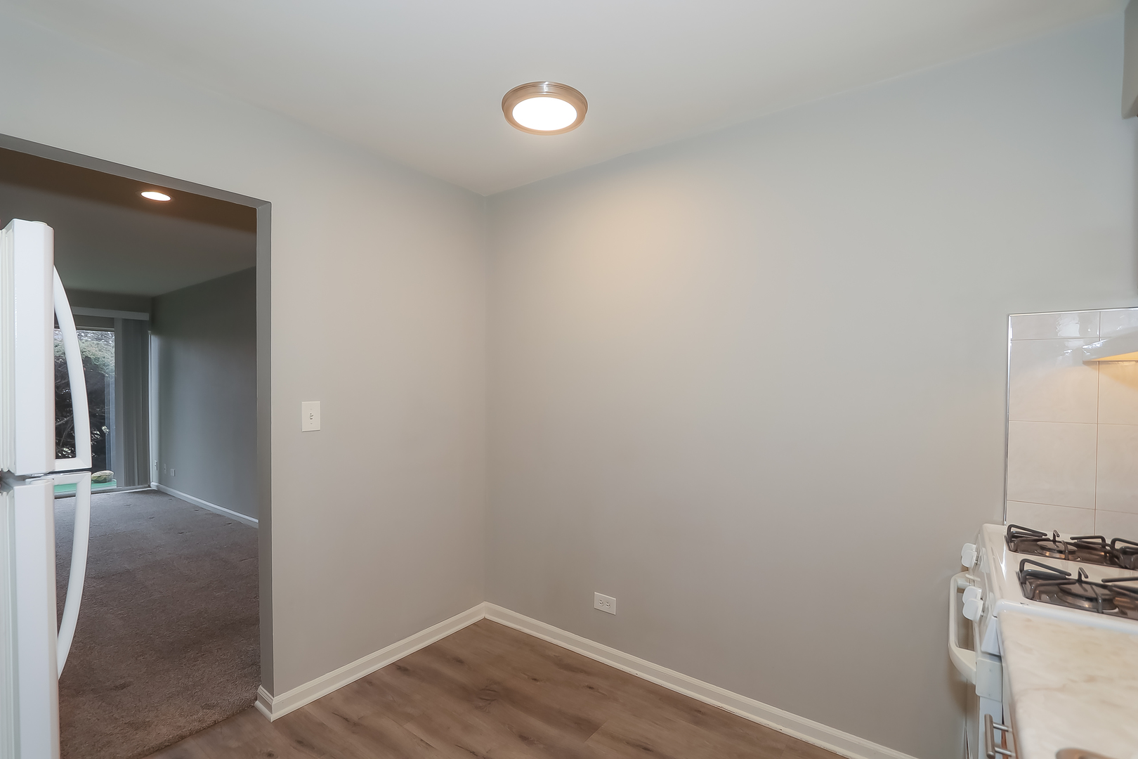 5000 Carriageway Drive, Unit 103 Rolling Meadows, IL 60008 - Photo 9 of 22 a view of a hallway with wooden floor and a sink
