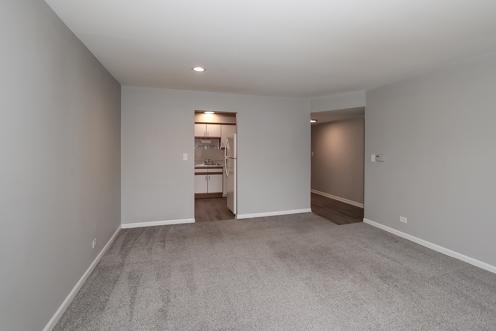5000 Carriageway Drive, Unit 103 Rolling Meadows, IL 60008 - Photo 10 of 22 a view of an empty room with a fireplace