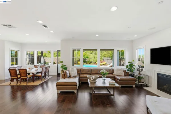 a living room with a couch and a potted plant
