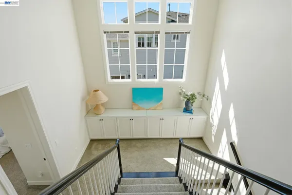 a bedroom with a bed and a flat tv screen on dresser