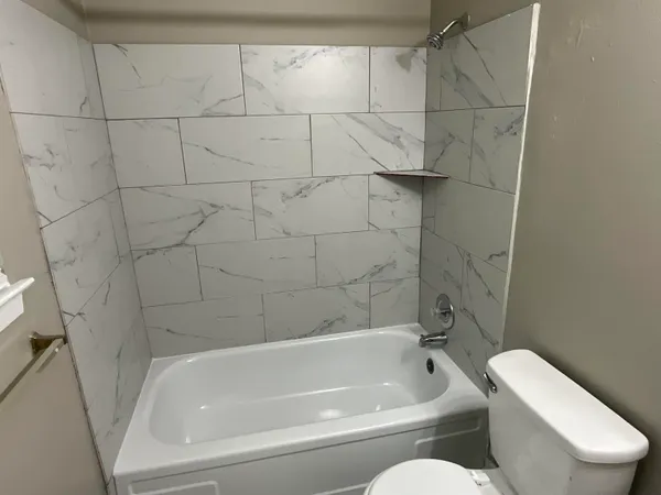 a bathroom with a toilet and bathtub